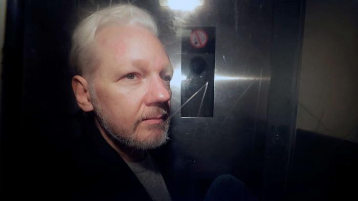 Read more about the article Assange To Be “Moved Around” Sine Die