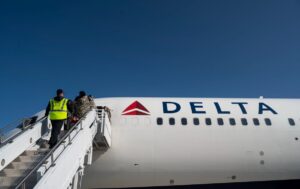 Read more about the article Evacuees enter a @Delta A350 767 commercial aircraft during at @RamsteinAirBase,